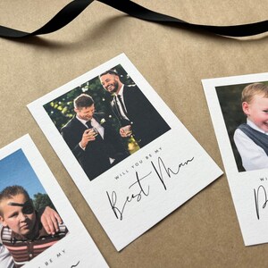 May include: White cards with photographs and black script text. One card reads "Will you be my Best Man" with a photo of two men in suits. Another card reads "Will you be our Page Boy" with a photo of a young boy.
