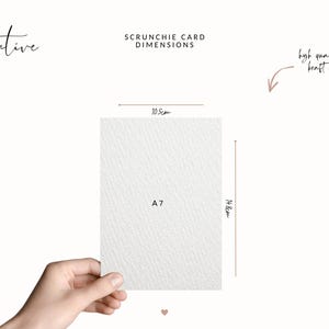 Puede incluir: Tarjeta A7 para coleteros, de 10,5 cm x 14,8 cm, sostenida por una mano. La tarjeta es blanca con una superficie texturizada. El texto en la tarjeta dice "A7". La imagen tambi&eacute;n incluye el texto "Scrunchie Card Dimensions" y "high quality kraft card".