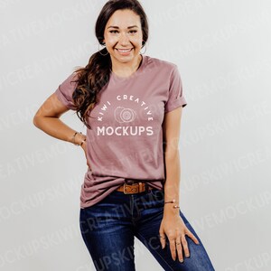 May include: A mauve t-shirt with a white graphic design that says "Kiwi Creative Mockups" with a drawing of two kiwi fruits.