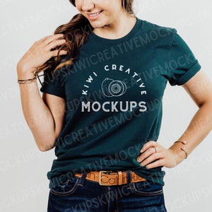 May include: A teal green t-shirt with a white graphic of two kiwi fruits and the text "Kiwi Creative Mockups".