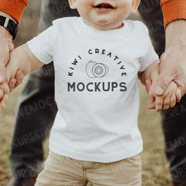 RABBIT SKINS 3322 White Mockup with Model, Lifestyle Baby T-Shirt Mockup, Blank White T-Shirt Cute Toddler Model Outside, Spring