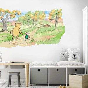 May include: Winnie the Pooh and Piglet walking along a path in the woods. The path is lined with autumn leaves. The background is a watercolour painting of trees and a sky.