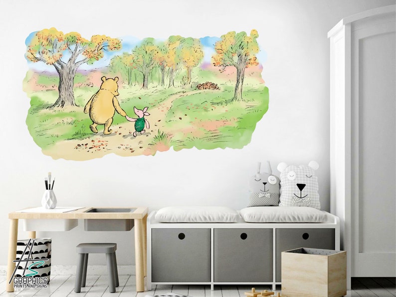May include: Winnie the Pooh and Piglet walking along a path in the woods. The path is lined with autumn leaves. The background is a watercolour painting of trees and a sky.