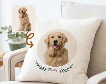 May include: A white cushion featuring a circular image of a golden retriever dog with the name "Pickle" written beneath. The image is encircled by green leafy branches.