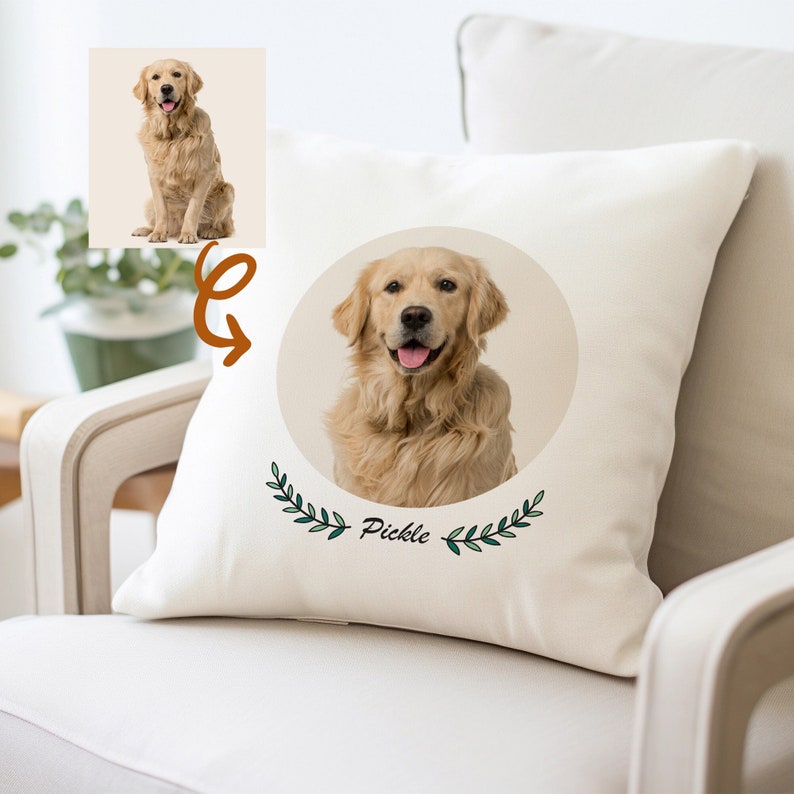 May include: A white pillow with a round image of a golden retriever dog with the name "Pickle" written below the image. The image is surrounded by green leafy branches.