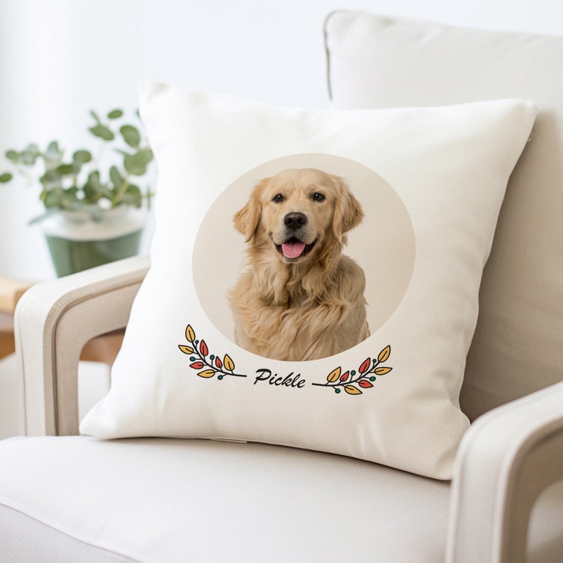 May include: A white throw pillow with a photo of a golden retriever dog in a circle with fall-colored leaves and the name "Pickle" printed below.