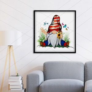 May include: A gnome wearing a red, white, and blue hat with a peace sign and holding a sunflower. The gnome is sitting on a bed of green grass with white flowers and butterflies.