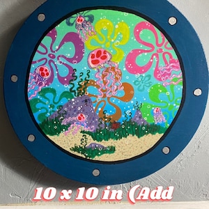 May include: Round canvas art featuring a vibrant underwater scene with jellyfish and colorful floral shapes. The artwork is framed in a dark blue circle with silver accents. The canvas measures 10 x 10 inches.