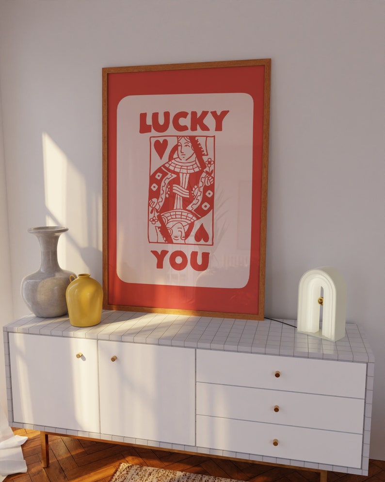 A light red playing card with the phrase Lucky You on top.