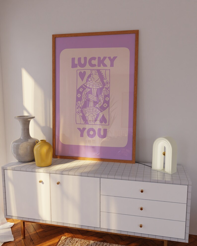 A purple playing card with the phrase Lucky You on top.