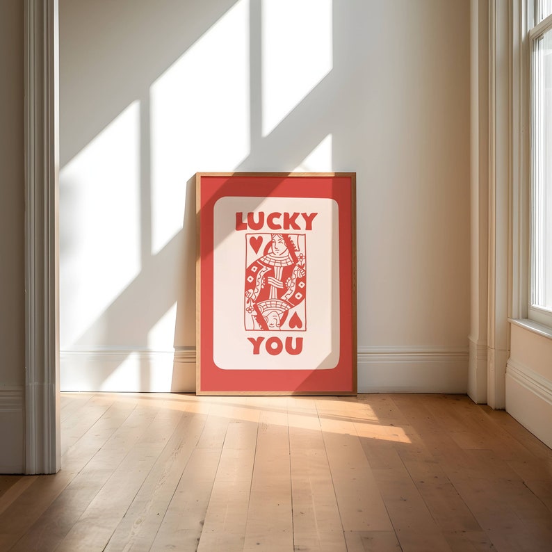 A light red playing card with the phrase Lucky You on top.
