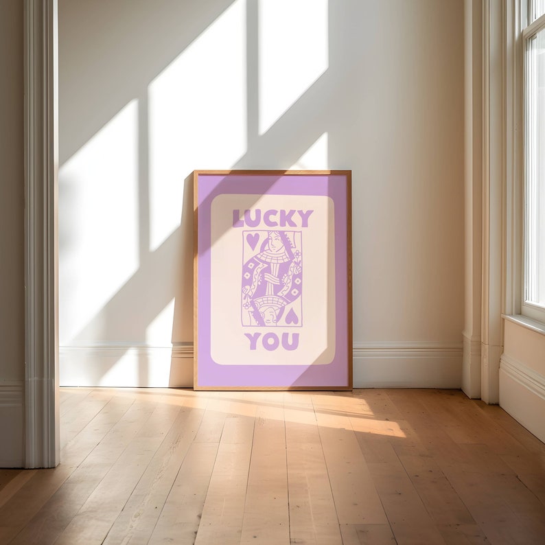 A purple playing card with the phrase Lucky You on top.