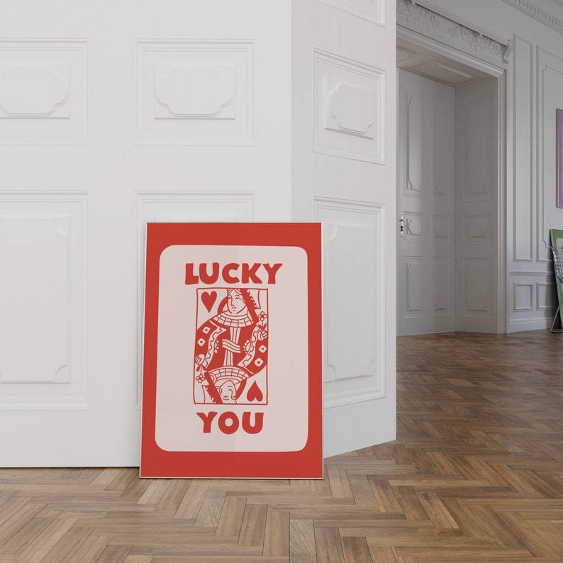 A light red playing card with the phrase Lucky You on top.