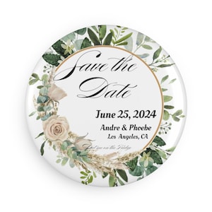 May include: A round white button with the text "Save the Date" in elegant script, surrounded by a floral wreath of green leaves, beige roses, and pampas grass. The date "June 25, 2024" and names are also displayed.