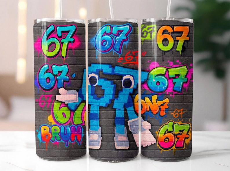 May include: Three stainless steel tumblers with a graffiti-style design. The design features the number "67" in various colours, including green, pink, and orange, set against a grey brick wall background. The word "BRUH" is also visible.
