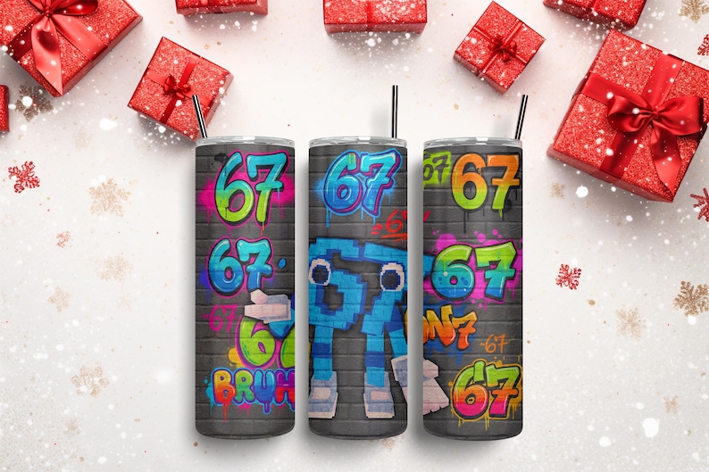 May include: Three stainless steel tumblers with black straws, each with a graffiti-style design. The number "67" is displayed in bright colours on each, set against a grey brick wall. Red gift boxes with bows and snowflakes surround the tumblers.