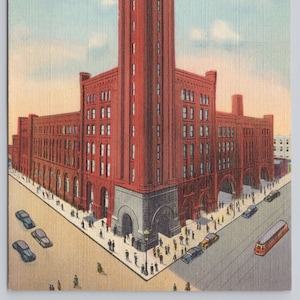 May include: A vintage postcard depicting the Grand Central Station in Chicago, Illinois. The postcard features a red brick building with a tall clock tower and a street scene with people and cars.