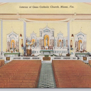 May include: Interior view of the Gesu Catholic Church in Miami, Florida. The church has a high vaulted ceiling and stained glass windows. The altar is decorated with religious statues and flowers. The pews are made of wood and are arranged in rows.