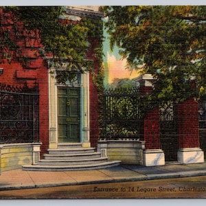 May include: Vintage postcard featuring the entrance to 14 Legare Street in Charleston, S.C. The image shows a red brick building with a green door and wrought iron gates. Lush greenery frames the entrance, with the text "Entrance to 14 Legare Street, Charleston, S.C."