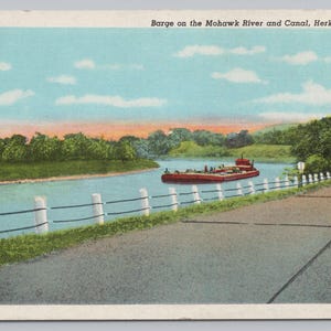 May include: Vintage postcard depicting a barge on the Mohawk River and Canal in Herkimer, NY. The scene shows a red barge on the water, a road, and a white fence. The sky is blue with clouds, and the text "Barge on the Mohawk River and Canal, Herkimer, N. Y." is visible.