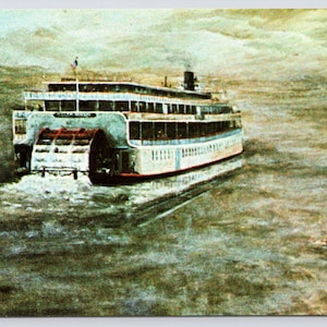 May include: A vintage postcard depicting a white steamboat with a large paddle wheel, moving through a foggy river. The boat has multiple decks and windows, and the paddle wheel is churning up the water.