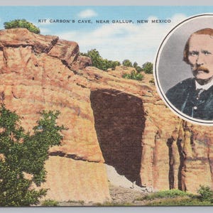 May include: Vintage postcard featuring Kit Carson's Cave near Gallup, New Mexico. The image shows a large, reddish-brown rock formation with a cave entrance. A portrait of a man in a black suit is in a circular frame. The sky is blue.