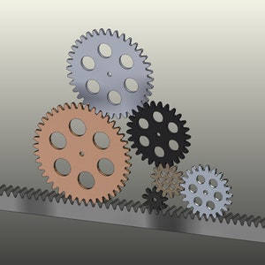 May include: A set of five gears, including a rack gear, in various sizes and colours. The gears are made of metal and have a silver, black, copper, and grey finish.
