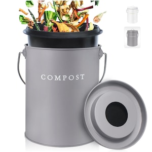 May include: A gray metal compost bin with a black lid and a white label that says "COMPOST". The bin has a removable lid with a hole in the center. The bin is filled with food scraps and other organic waste.