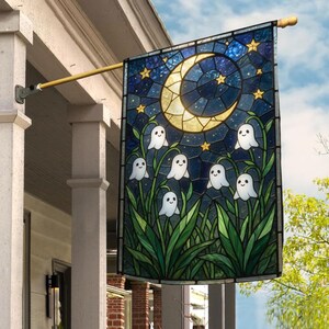 May include: A rectangular garden flag featuring a stained glass style design of a yellow crescent moon and small stars against a dark blue night sky, with six white ghost figures emerging from green lily of the valley style foliage.