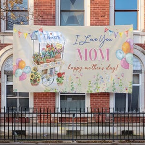 May include: A banner with a watercolor floral design. The banner has a light brown background with a light blue and white flower cart with a sign that says 