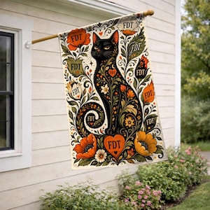 May include: A rectangular garden flag featuring a black cat silhouette filled with intricate floral patterns in orange, yellow, and green. The text FDT is repeated multiple times throughout the design, including within a central orange heart shape.