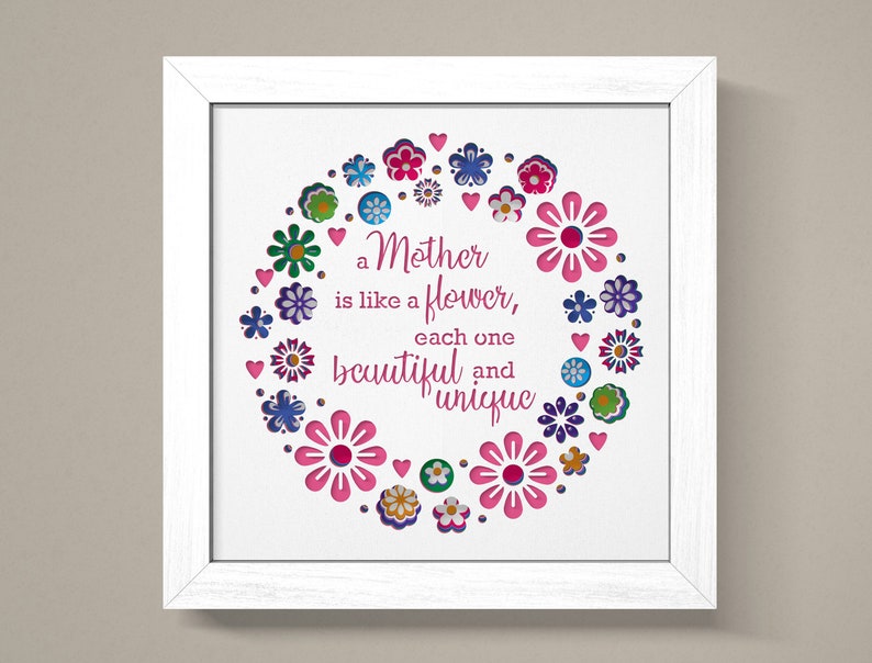May include: White framed print with a pink, green, blue, and purple floral design. The text reads "a Mother is like a flower, each one beautiful and unique."