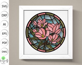 May include: A stained glass style illustration of pink magnolia flowers in a circular frame. The flowers are surrounded by green leaves and a blue background.