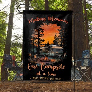 May include: A black garden flag with a sunset scene and a camper van. The text reads "Making Memories One Campsite at a time - The Smith Family".