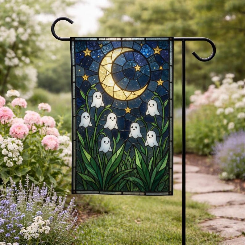 May include: A rectangular garden flag featuring a stained glass style design of a yellow crescent moon and golden stars against a dark blue night sky, with white ghost figures emerging from green leafy plants at the bottom of the scene.