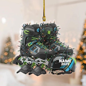 May include: A decorative ornament featuring a pair of inline skates, knee pads, and a helmet, all adorned with colorful Christmas lights. The helmet has the text "NAME 2025". The skates are black, gray, and green.