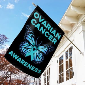 May include: A black garden flag with a teal butterfly and the text "Ovarian Cancer Awareness".