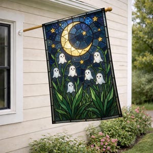May include: A rectangular garden flag featuring a stained glass style design of a glowing yellow crescent moon and golden stars against a dark blue night sky, with several small white ghost figures emerging from green leafy plants below.