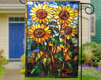 May include: A stained glass garden flag featuring a colorful design of three sunflowers with green leaves against a blue sky background.