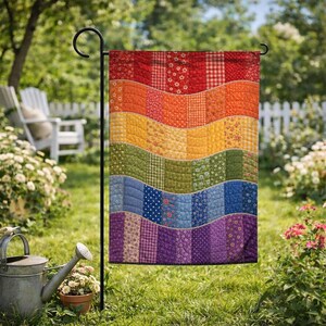 May include: A rectangular garden flag featuring a quilted design with horizontal wavy bands in a rainbow color gradient. The fabric displays various patterns including floral, gingham, and polka dot prints in red, orange, yellow, green, blue, and purple.