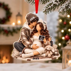 May include: A flat acrylic Christmas ornament featuring a couple sitting together. The person on the left wears a brown plaid shirt and a beanie labeled JACK. The person on the right wears a cream dress and a headband labeled LILY, holding an ultrasound image. A small plush bunny sits nearby, and the year 202X is printed at the bottom.