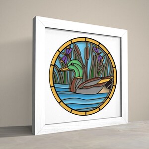 May include: A stained glass style illustration of a green duck swimming in blue water with green reeds and purple flowers.