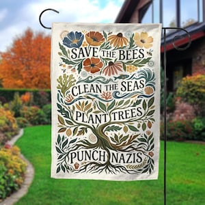 May include: A garden flag with the text "Save the Bees, Clean the Seas, Plant Trees, Punch Nazis" in a decorative font. The flag features illustrations of flowers, bees, fish, and a tree.