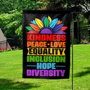 May include: A black garden flag with a rainbow sunflower design and the words "Kindness, Peace, Love, Equality, Inclusion, Hope, Diversity".