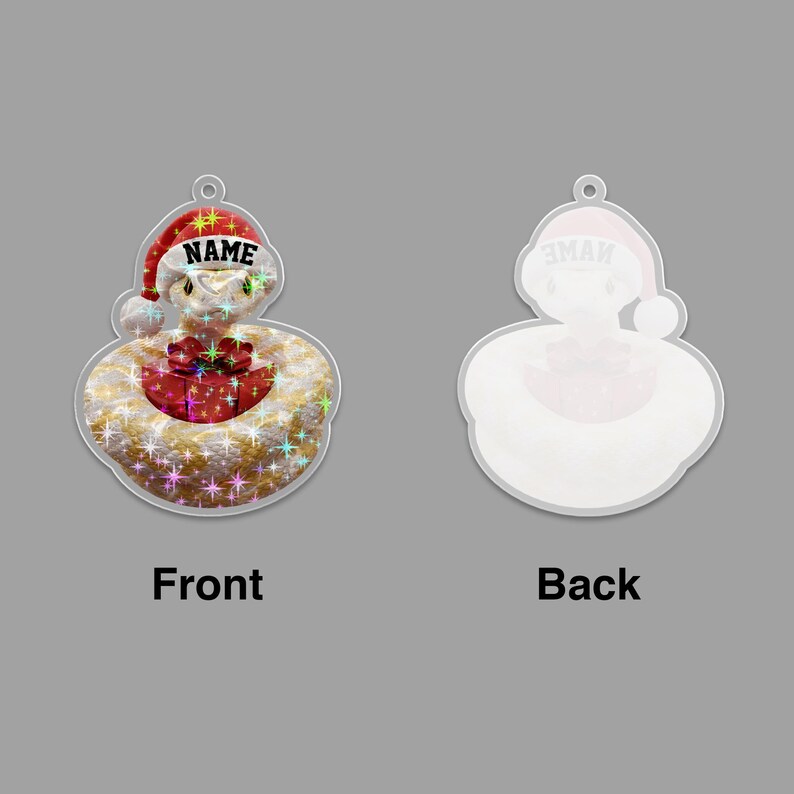 May include: A clear, snake-shaped Christmas ornament with a Santa hat and a gift. The front side has the word "NAME" on the hat and a gift. The back side has the word "NAME" on the hat.
