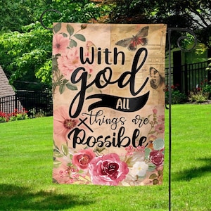 May include: A garden flag with a floral design and the text "With god all things are possible".