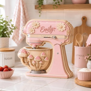 May include: A layered wooden stand mixer cutout in a light pink finish. The mixer features a script name Emily, wooden daisy accents, and a bowl decorated with small pink and white mushroom figures. The design includes a speed control dial.