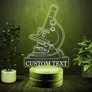 May include: A white outline of a microscope on a wooden base with a light green glow. The base has a white text box that says "CUSTOM TEXT".