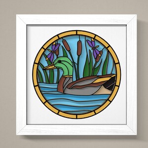 May include: A stained glass style illustration of a duck swimming in a pond with cattails and a dragonfly. The duck is green, brown, and grey. The water is blue and the cattails are green and brown. The dragonfly is purple and blue.