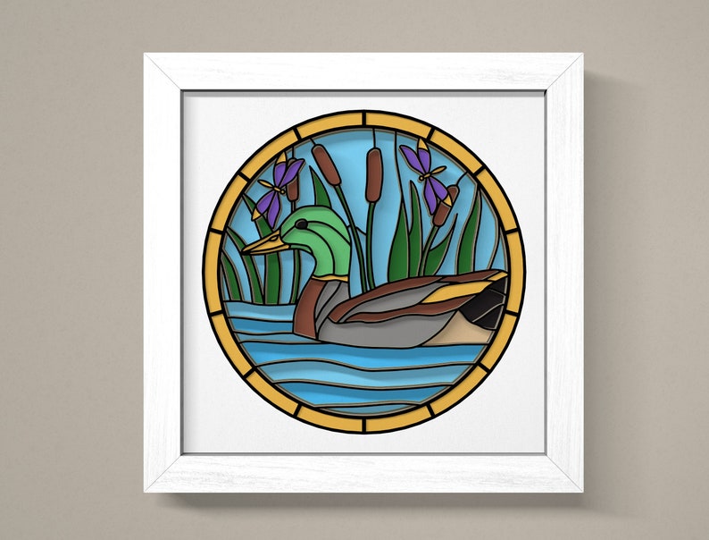 May include: A stained glass style illustration of a duck swimming in a pond with cattails and a dragonfly. The duck is green, brown, and grey. The water is blue and the cattails are green and brown. The dragonfly is purple and blue.